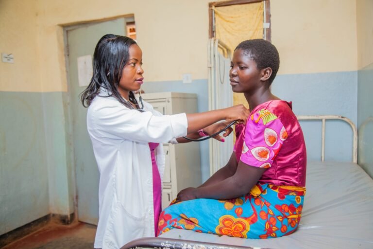 Malawi_Header_Deborah-Kazembe-Medical-Assistant-at-Nkhonjeni-Health-Centre-in-Thyolo-checking-a-patients-blood-pressure-and-heartbeat-.-Photo-by-Moving-Minds-scaled